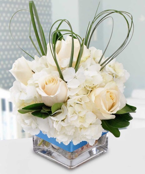 Welcome a special baby boy with this adorable arrangement filled with garden flowers such as hydrangea, sweet roses and dancing fancy greens. 