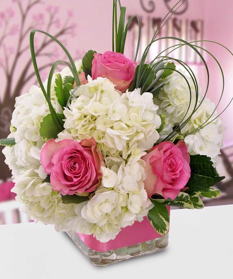 Welcome a beautiful baby girl with this adorable arrangement filled with garden flowers such as hydrangea, sweet roses and dancing fancy greens. 