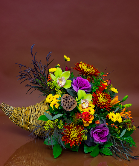 We will combine a beautiful collection of fresh seasonal flowers in a traditional cornucopia.