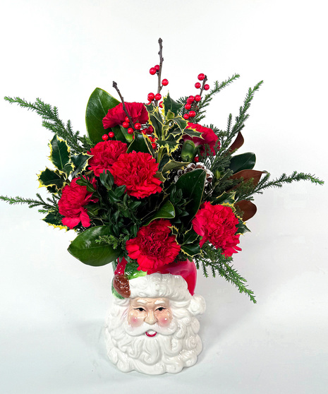 This year's signature ceramic piece is a substantial arrangement of mixed evergreens roses or carnations, cinnamon sticks, pine cones and baubles.