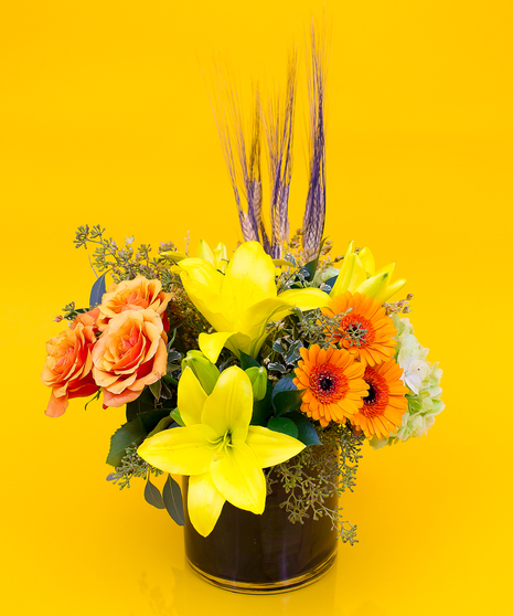  popular seasonal flowers including roses, fragrance free lilies, gerbera daisies and autumn accent flowers as a finishing touch to create this beautiful design.