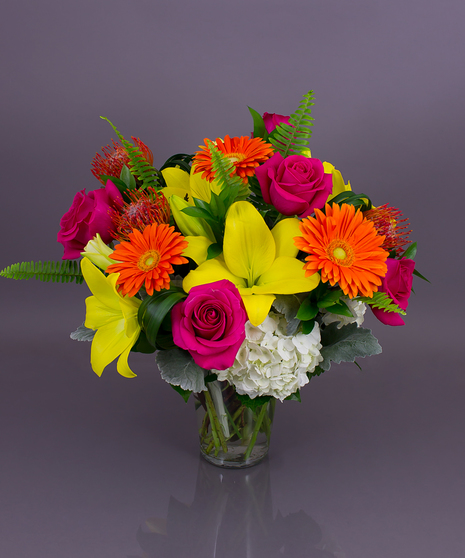 his garden style design features vivid hybrid lilies (fragrance-free), gorgeous Gerbera daisies, lush hydrangea, and premium 