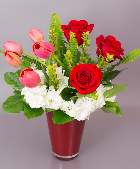 This bouquet has it all....premium roses, our own Danvers Grown tulips, and beautiful hydrangea. Send a smile, choose the Currans Valentine Vase.