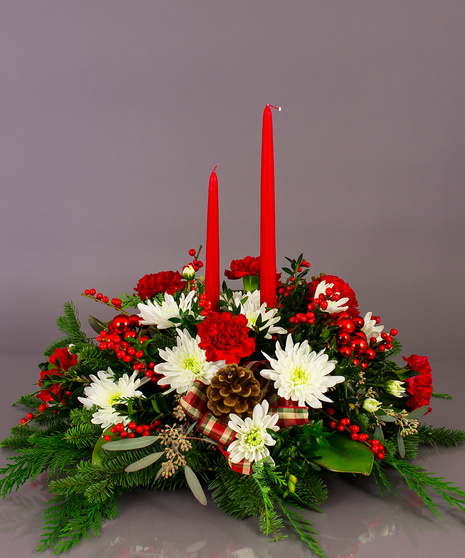 Our long lasting table centerpieces are designed from a variety of fresh cut winter greens, carnations or roses, and berries.