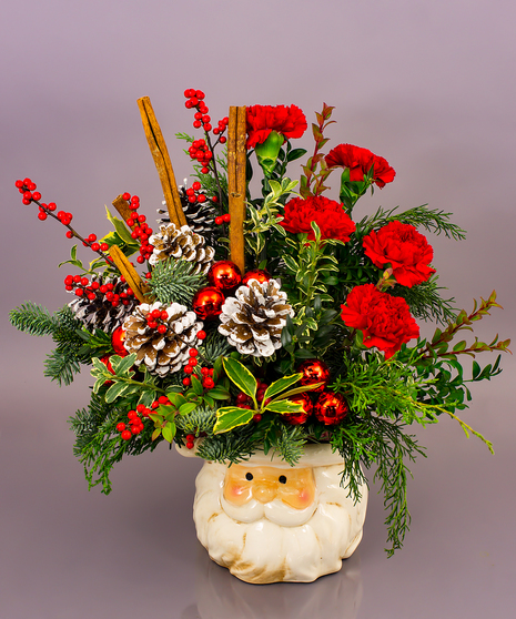 This year's signature ceramic piece is a substantial arrangement of mixed evergreens roses or carnations, cinnamon sticks, pine cones and baubles.