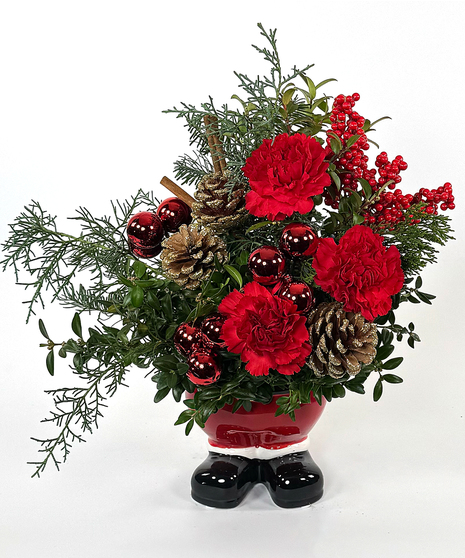 This year's signature ceramic piece is a substantial arrangement of mixed evergreens roses or carnations, cinnamon sticks, pine cones and baubles.