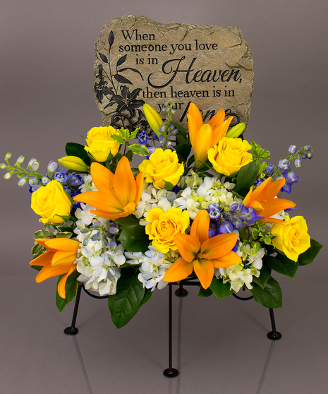 We will create a beautiful floral floral arrangement to celebrate a loved one and display your selected memorial plaque above it in our display stand.