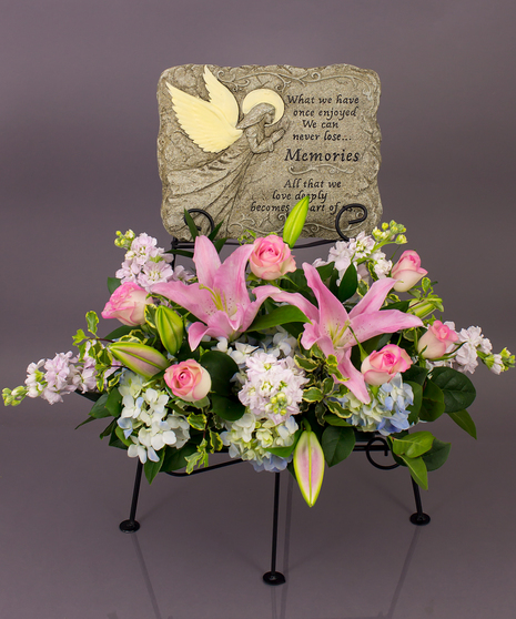 We will create a beautiful floral floral arrangement to celebrate a loved one and display your selected memorial plaque above it in our display stand.