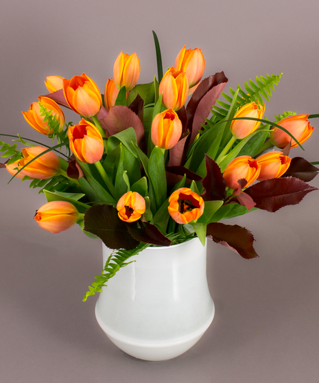 We have designed premium Adrem tulips and photinia foliage in our exclusive imported Tokyo vase to create this beautiful arrangement.