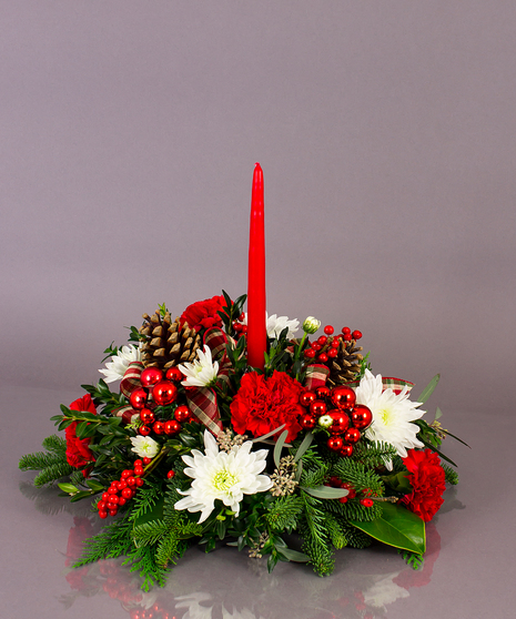 Our long lasting table centerpieces are designed from a variety of fresh cut winter greens, carnations, and berries.