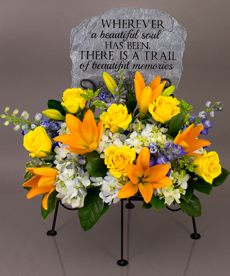 We will create a beautiful floral floral arrangement to celebrate a loved one and display your selected memorial plaque above it in our display stand.