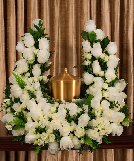 A beautiful collection of white roses artfully designed to embrace the memorial urn. Cut Phalaenopsis Elegance Vase