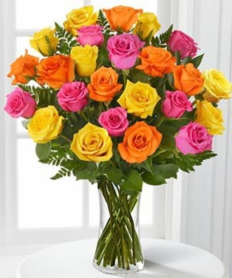 Beautiful hand-picked roses in assorted colors designed in a glass vase with mixed greenery.