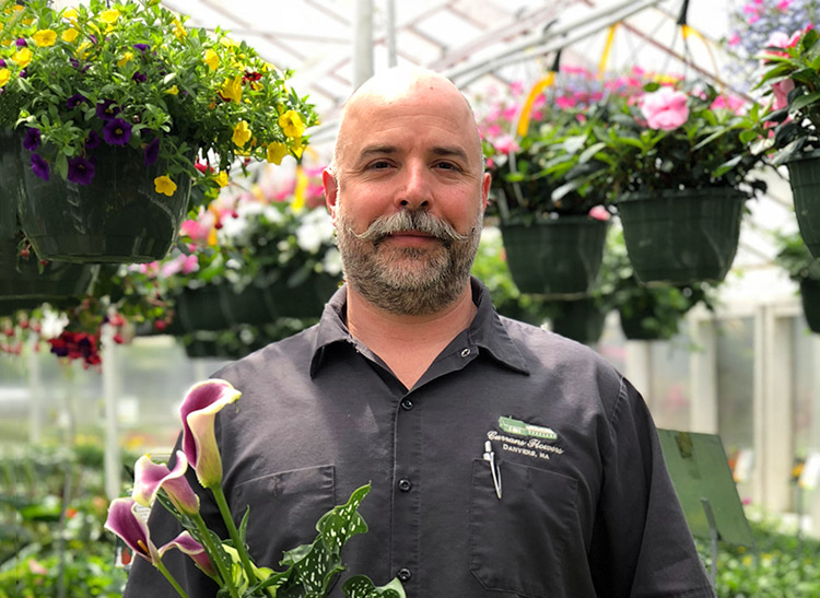 Paul Jr. poses with a potted plant in our spacious greenhouse